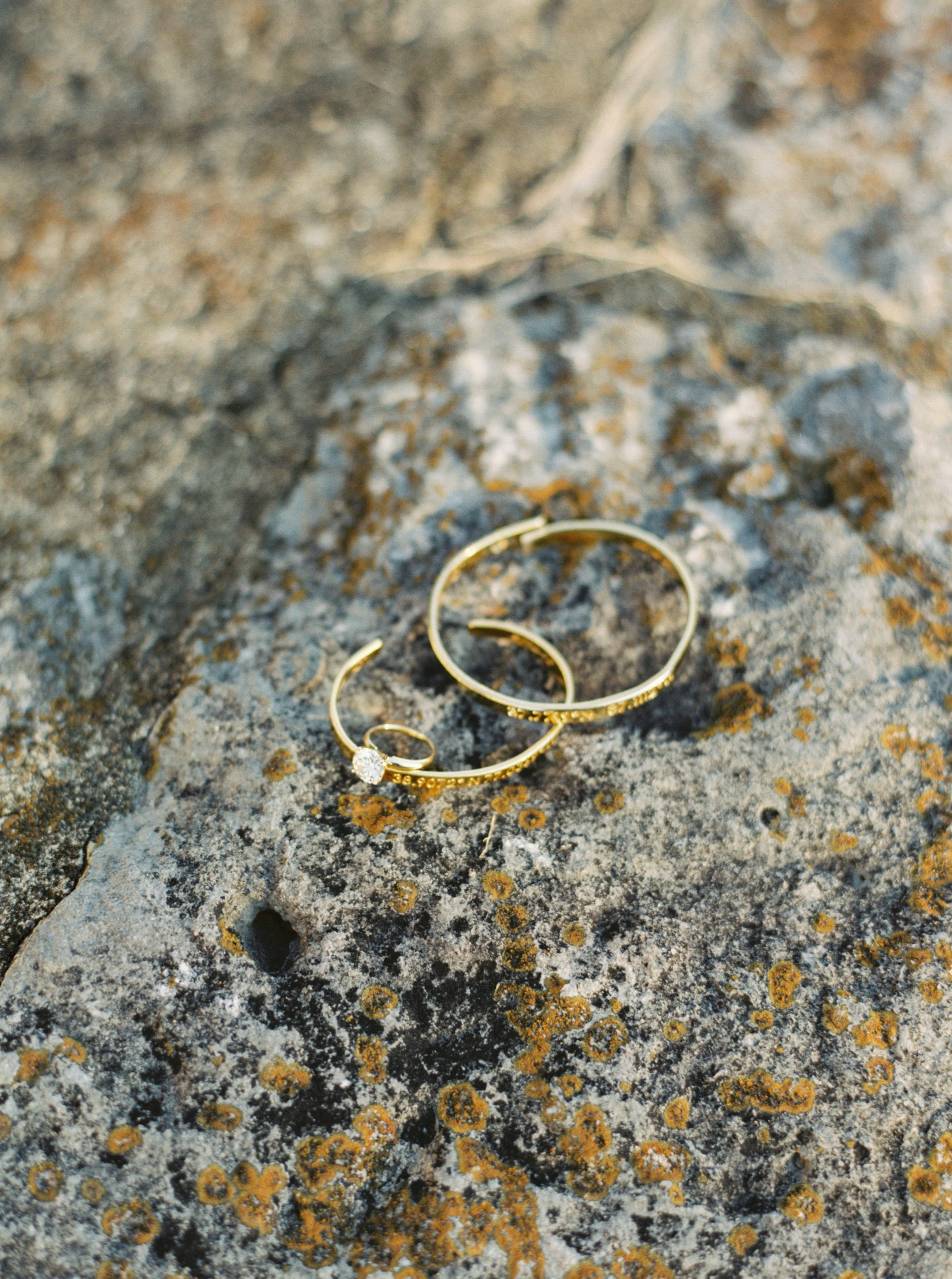 bangles and engagement ring on stone background