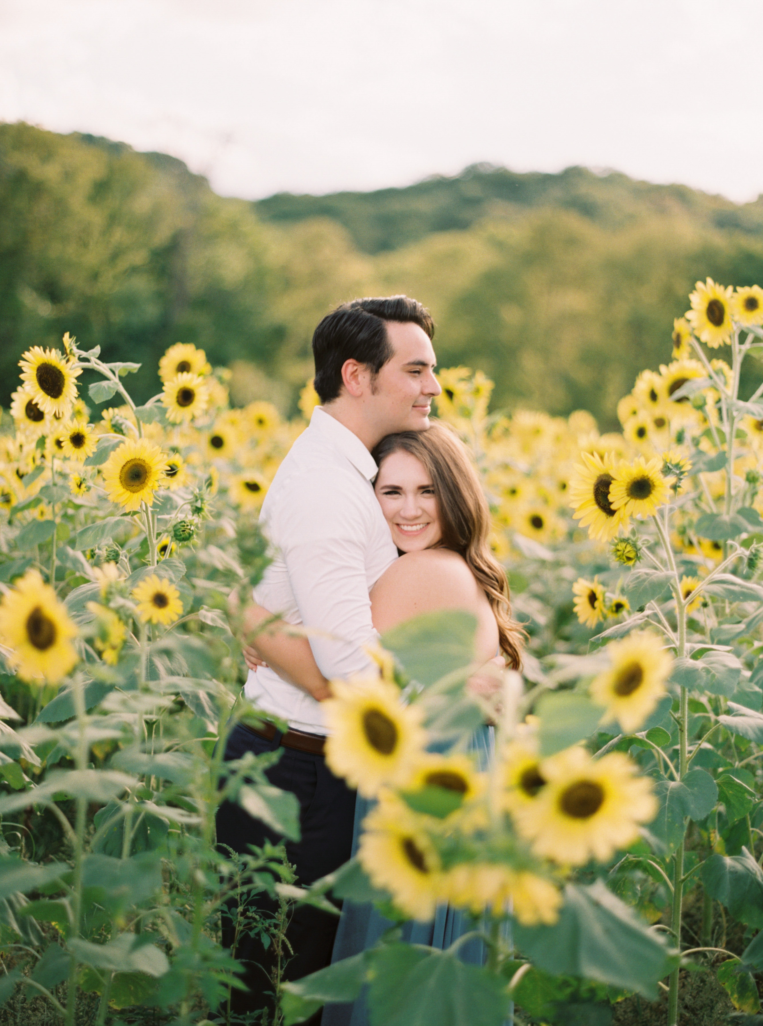 rich in color photo of couple in sunflowers