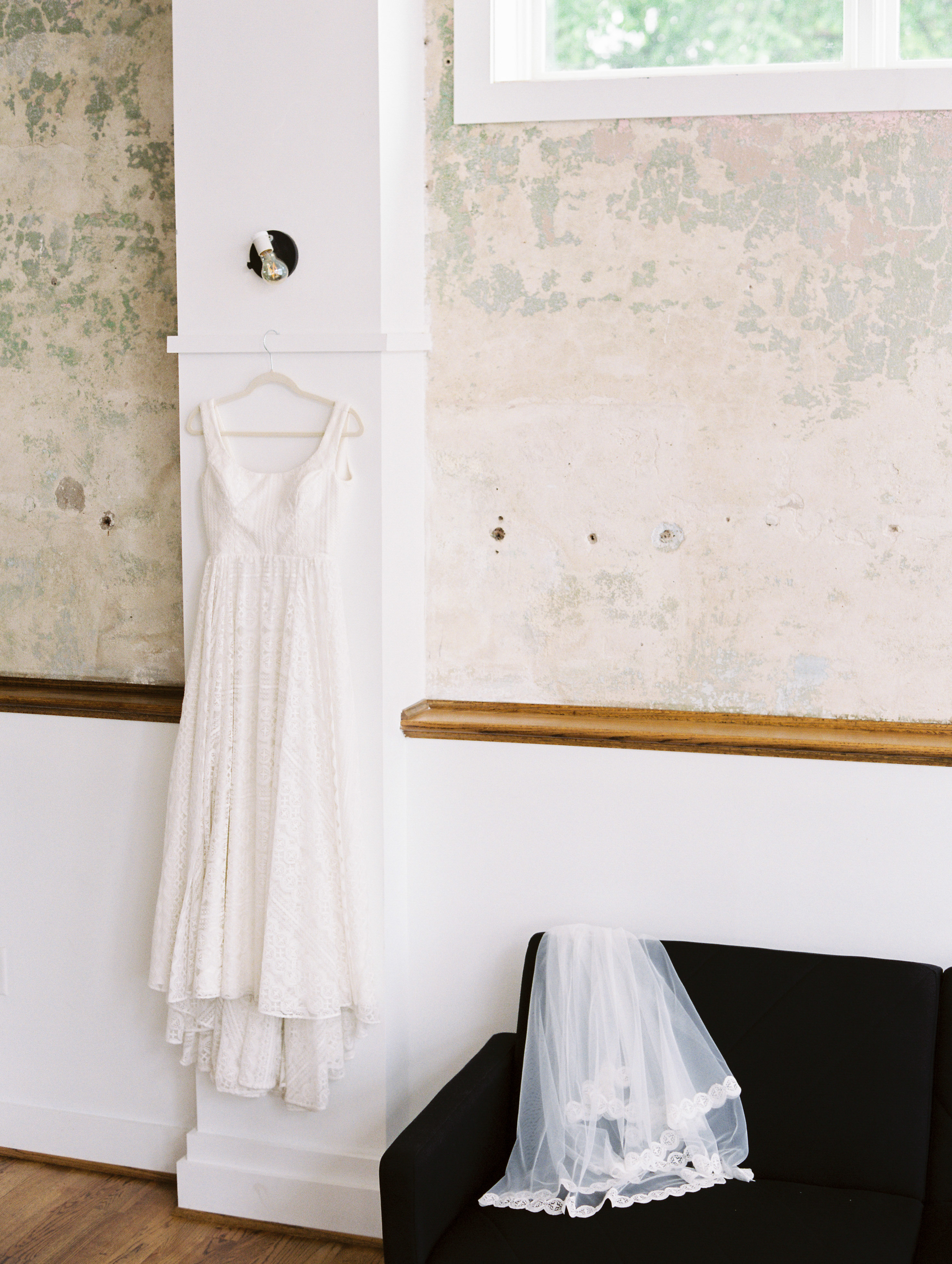 wedding dress and veil hanging in venue