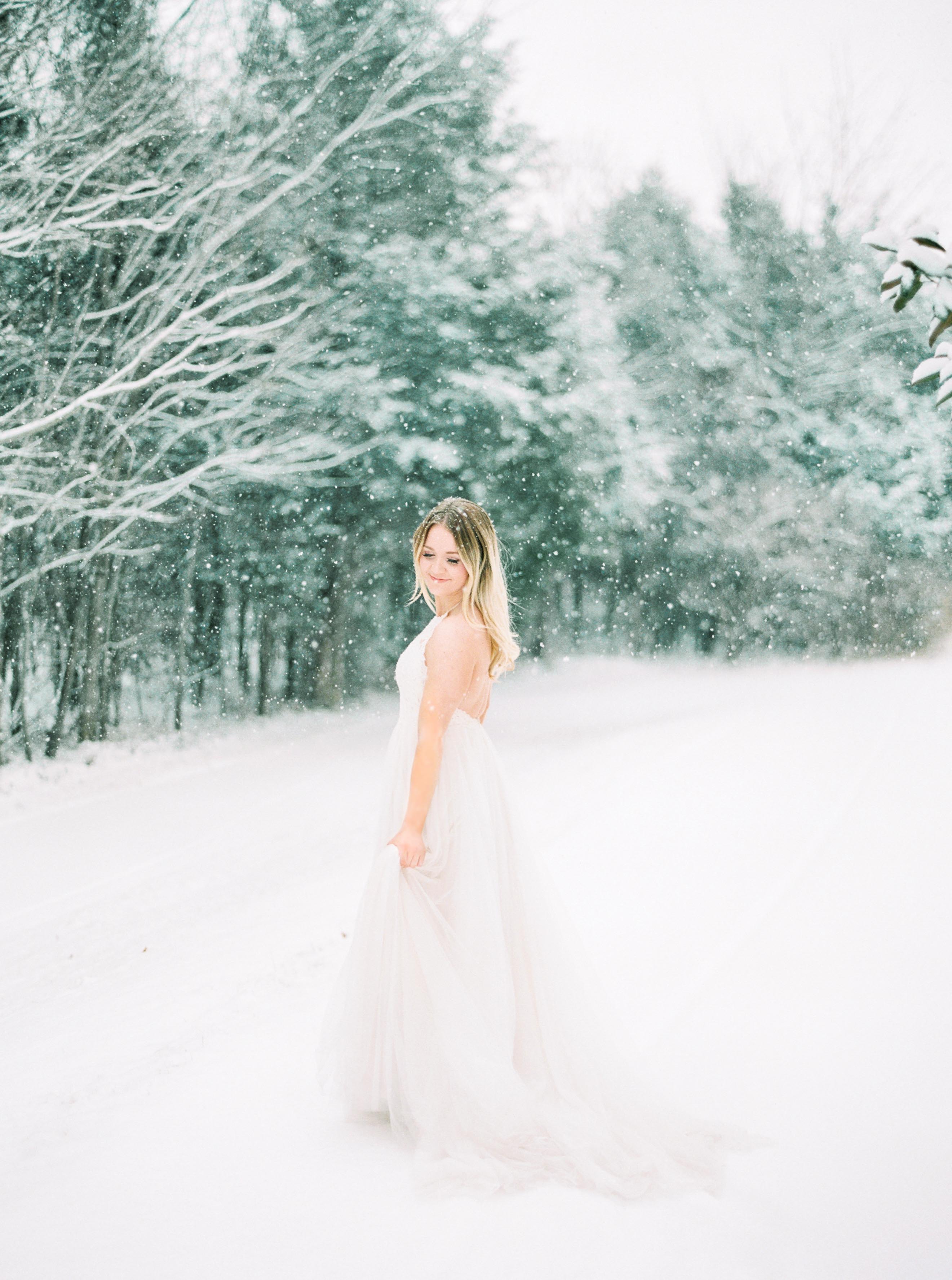 Bride showing BHLDN gown in snow