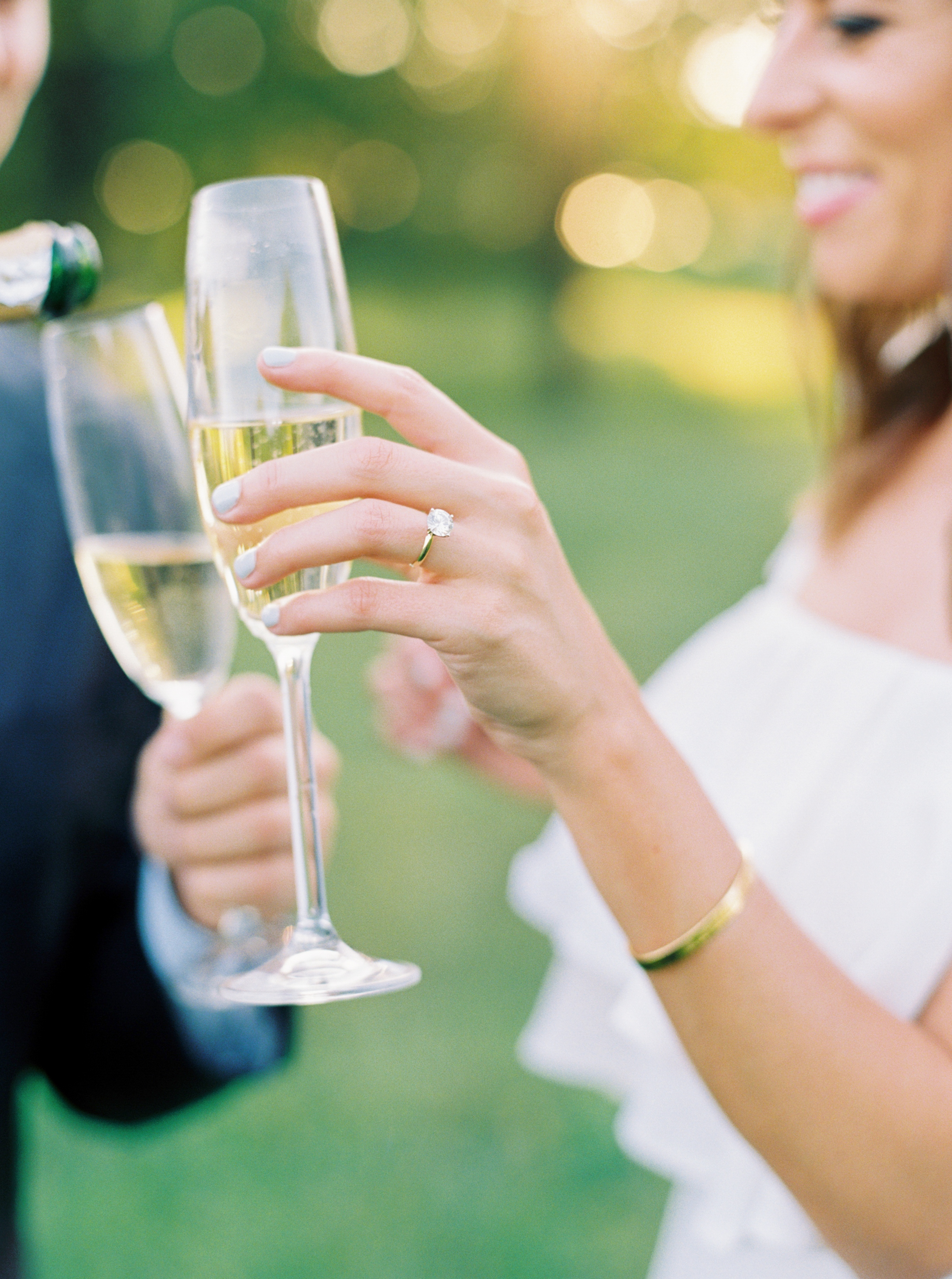 Couple sharing champagne at their engagement session